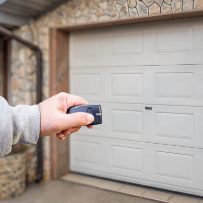 Auburn security key fob pointing to a garage door